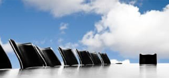 Large meeting table with empty chairs and clouds